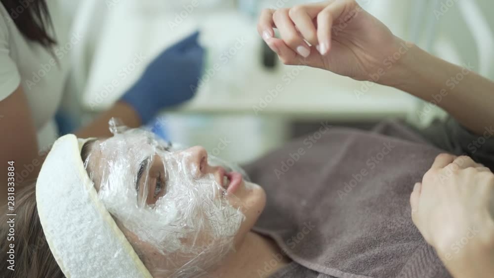 Young girl chatting with her therapist during beauty treatment Young girl chatting with her therapist during beauty treatment