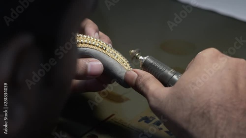 Hand polishing gold jewelry chain jeweler. Production and making manufacturing. 4K photo