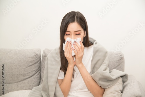 Asian women with stress that suffer from allergies and close the nose with tissue paper. Because of having sneezing all the time ..