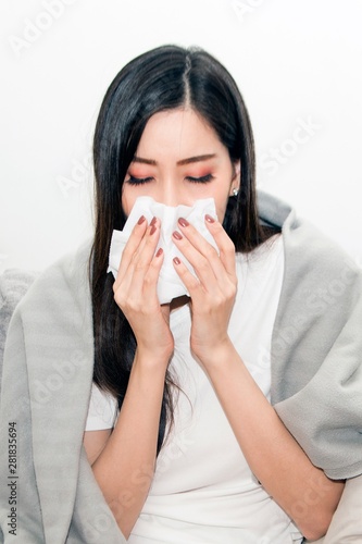 Asian women with stress that suffer from allergies and close the nose with tissue paper. Because of having sneezing all the time ..