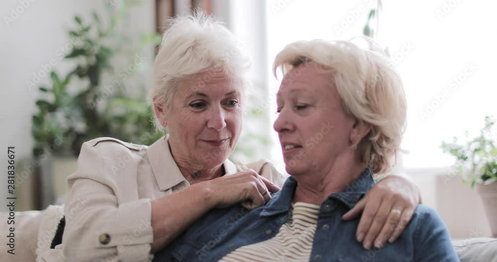 Mature lesbian couple at home on sofa Stock Video | Adobe Stock