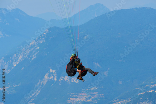 Paraglider flying over the Garda Lake Panorama of the gorgeous Garda lake surrounded by mountains. Paragliding is very popular sport in Monte Baldo. 