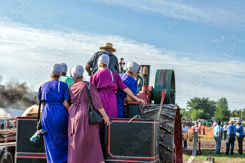 Amish Ladies Join Dad on Steam Engine photo