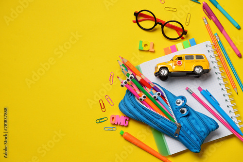 Colorful Back to School concept - office and student supplies on yellow background. Space for text.