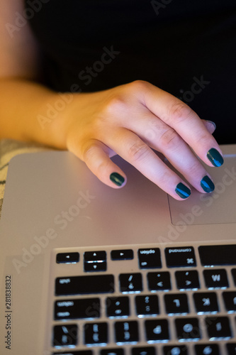 Female Hand Typing on Laptop Keayboard photo