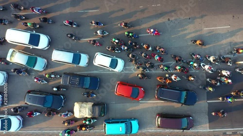 JAKARTA, Indonesia - July 30, 2019: Top down view of crowded motorcycle and cars moving on the road at rush hour in Jakarta downtown. Shot in 4k resolution photo