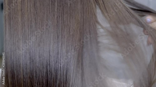 Wallpaper Mural hairdresser makes hair lamination in a beauty salon for a girl with brunette hair Torontodigital.ca