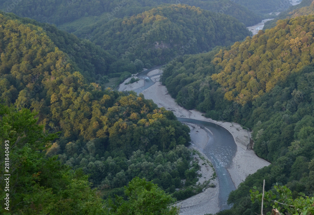 Fototapeta premium Blue clear water of the river. Cold mountain river flows between cliffs.