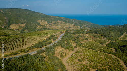 Crimean roads: aerial view of curvy mountain road in summer day