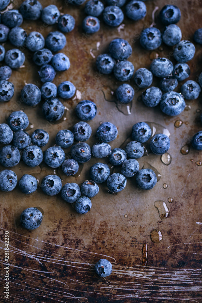 Fresh blueberries on a rustic metal surface