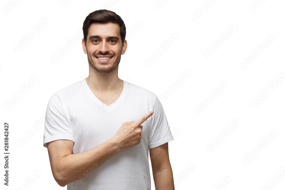 Young man in casueal t-shirt pointing right with his finger isolated on white background Young man in casueal t-shirt pointing right with his finger isolated on white background