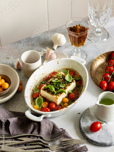 Baked feta cheese with cherry tomatoes and herbs