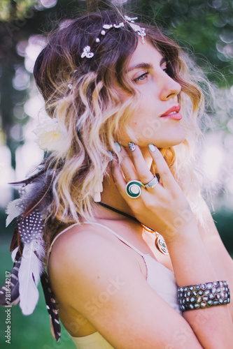 Bohemian hippie girl in white dress. Woman hands with lot of boho style jewelry, blue rings,silver bracelets and henna tattoo. Coachella Fashion Style Idea, outfit .