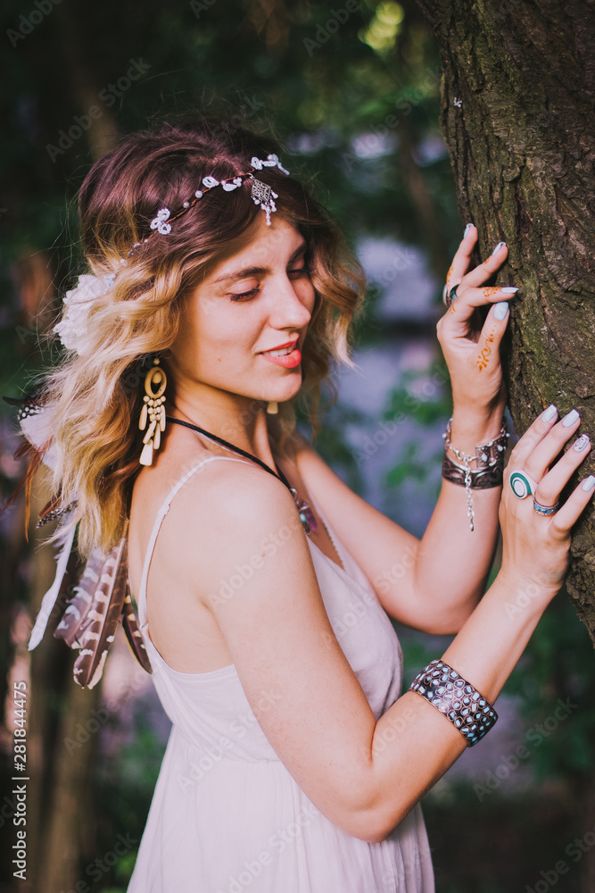 Bohemian hippie girl in white dress. Woman hands with lot of boho style  jewelry, blue rings,silver bracelets and henna tattoo. Boho lifestyle. Bohemian  Style Stock Photo