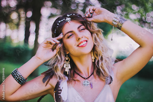 Bohemian hippie girl in white dress. Woman hands with lot of boho style jewelry, blue rings,silver bracelets and henna tattoo. Coachella Fashion Style Idea, outfit .