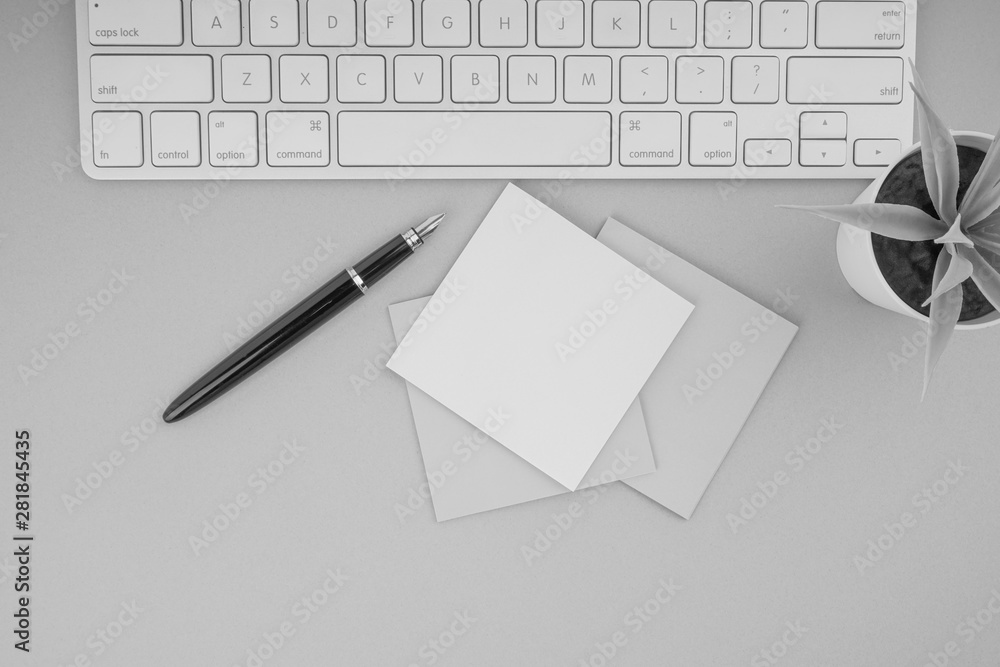 Flat lay, top view office table desk. Workspace with pen, sticky notes, decoration vase and keyboard on Black and White. Business Finance, Education and Copy Space concept Flat lay, top view office table desk. Workspace with pen, sticky notes, decoration vase and keyboard on Black and White. Business Finance, Education and Copy Space concept