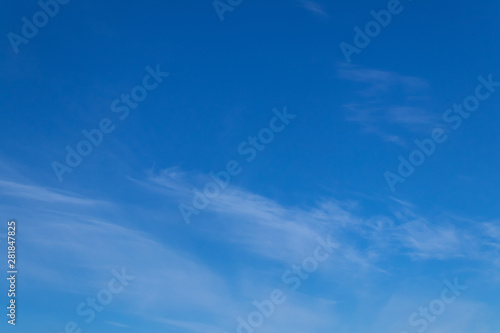 Blue sky background with tiny clouds