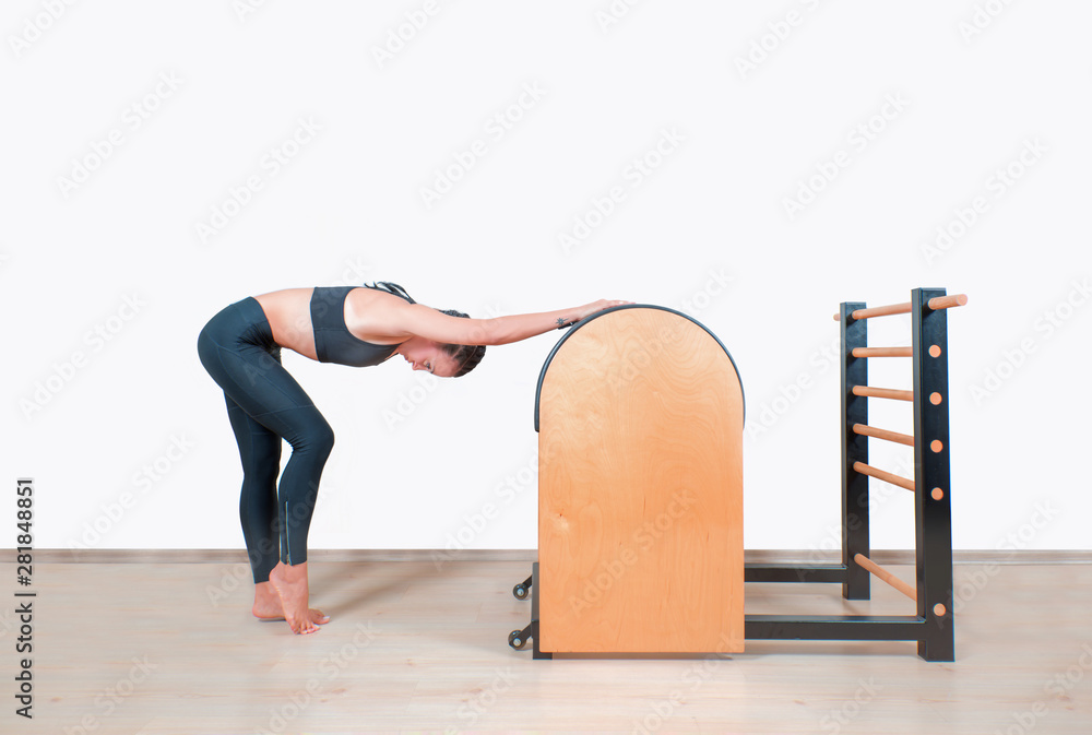 Young Girl doing exercises on ladder barrel - Pilates Stock Photo