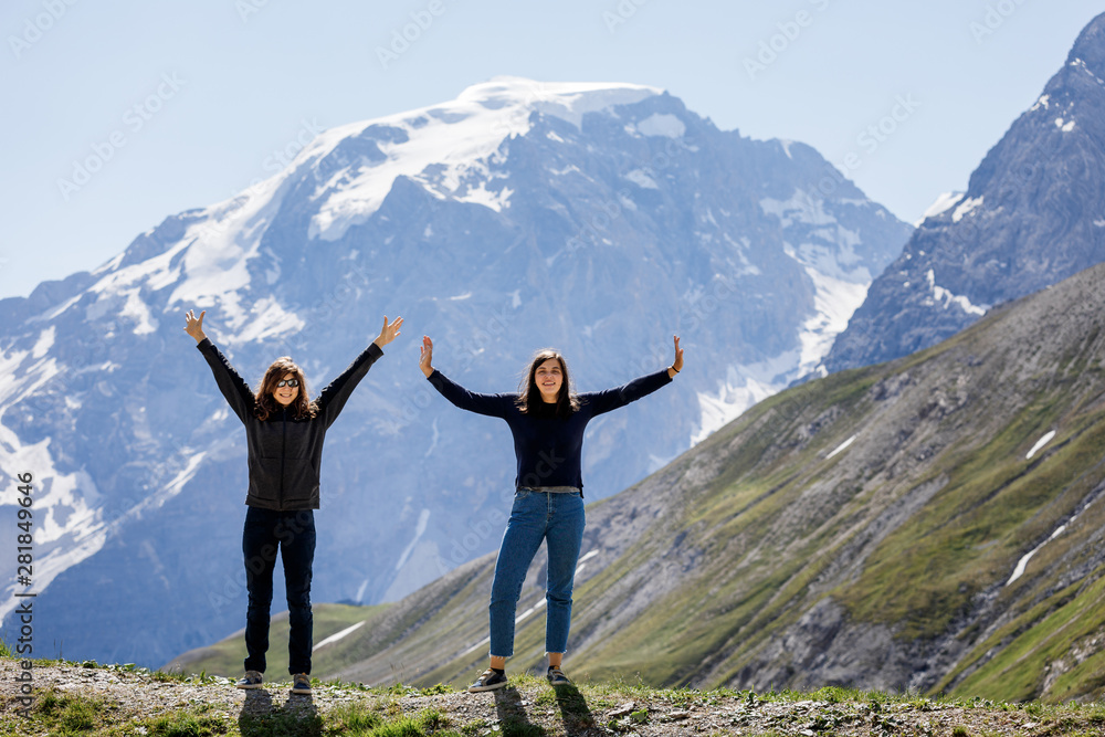 two girls on a background of mountains two girls on a background of mountains
