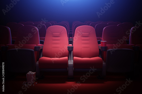 Interior of empty movie theater with red seats photo