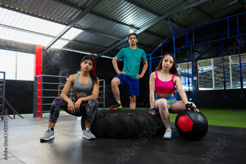 group of latin friends training crossfit in the gym looking at camera- angular shot