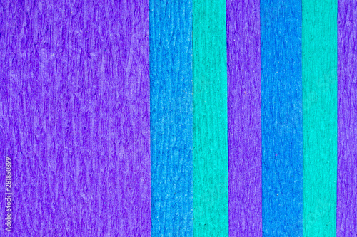Abstract textured background of the close up detail of sheets of blue and purple crepe paper