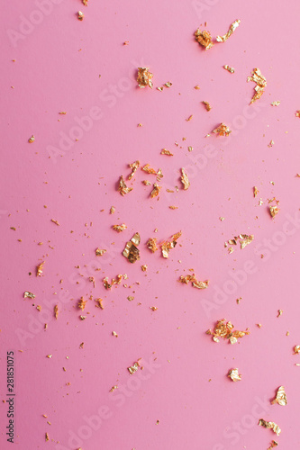 pieces of gold on a pink bright background