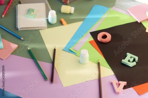 Bright colored paper, letters, stationery on the table, top view, background for inscriptions, back to school, education
