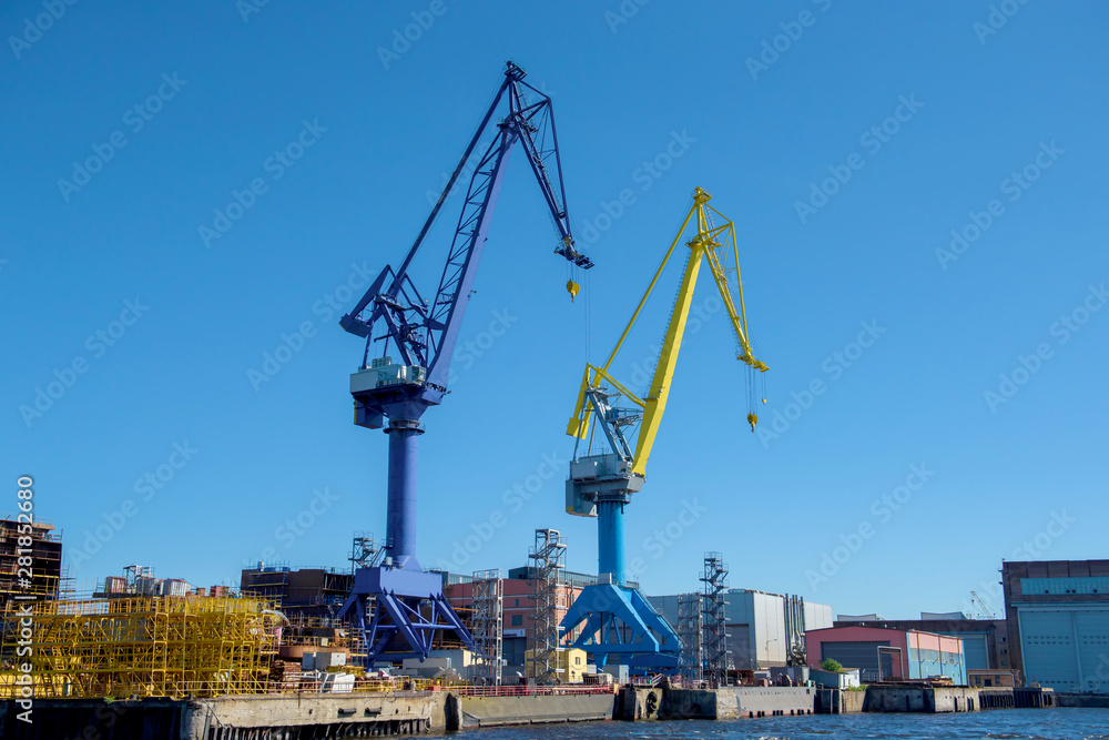 Loading cranes at the sea port. Cargo transportation by ships.