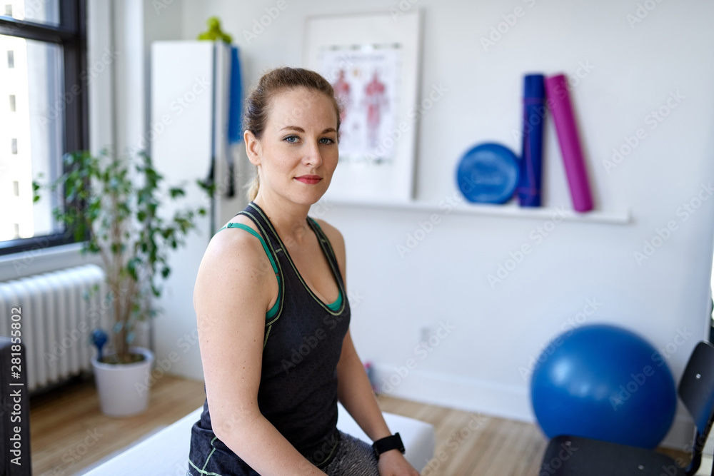 portrait of a personal trainer in a medical office