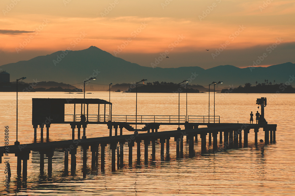 Kids playing on a pier at Guanabara Bay in the late afternoon Kids playing on a pier at Guanabara Bay in the late afternoon