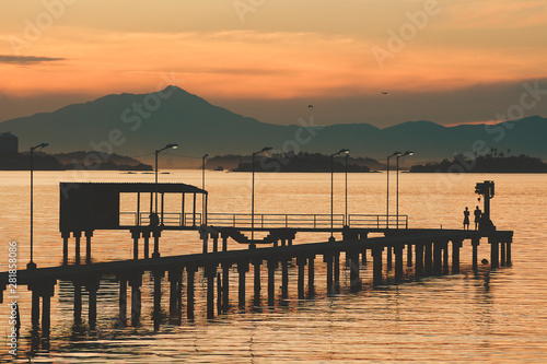 Kids playing on a pier at Guanabara Bay in the late afternoon