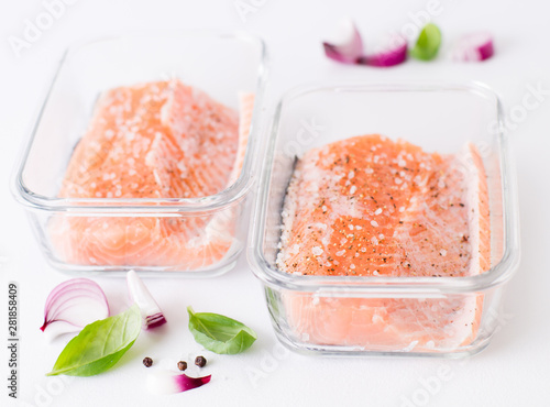 Piece of salmon marinated in a glass container