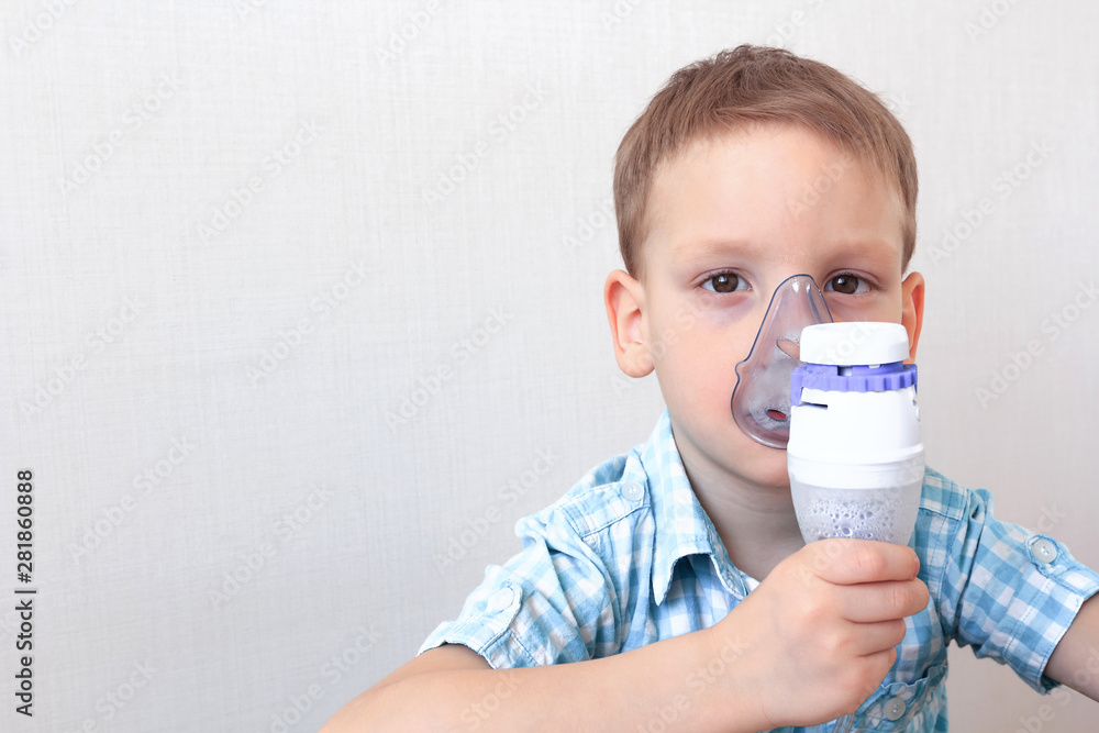 Child holding nebulizer on white background. Allergy concept