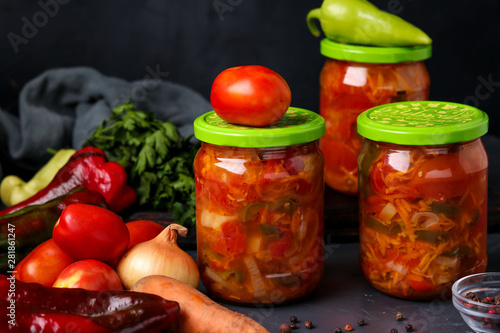 Vegetable salad in jars for the winter of tomatoes, carrots, onions and peppers, horizontal arrangement photo