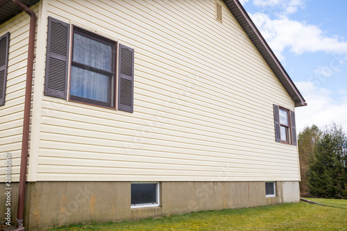 House with pale yellow vinyl siding