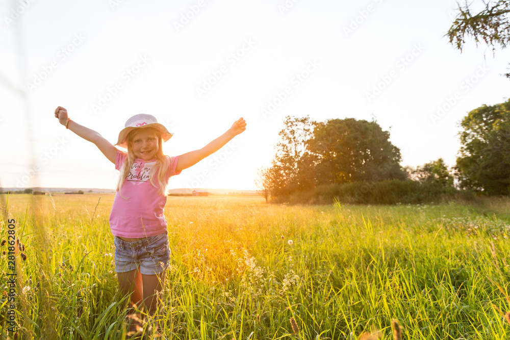 Happy girl enjoying the sunset at the countryside Happy girl enjoying the sunset at the countryside