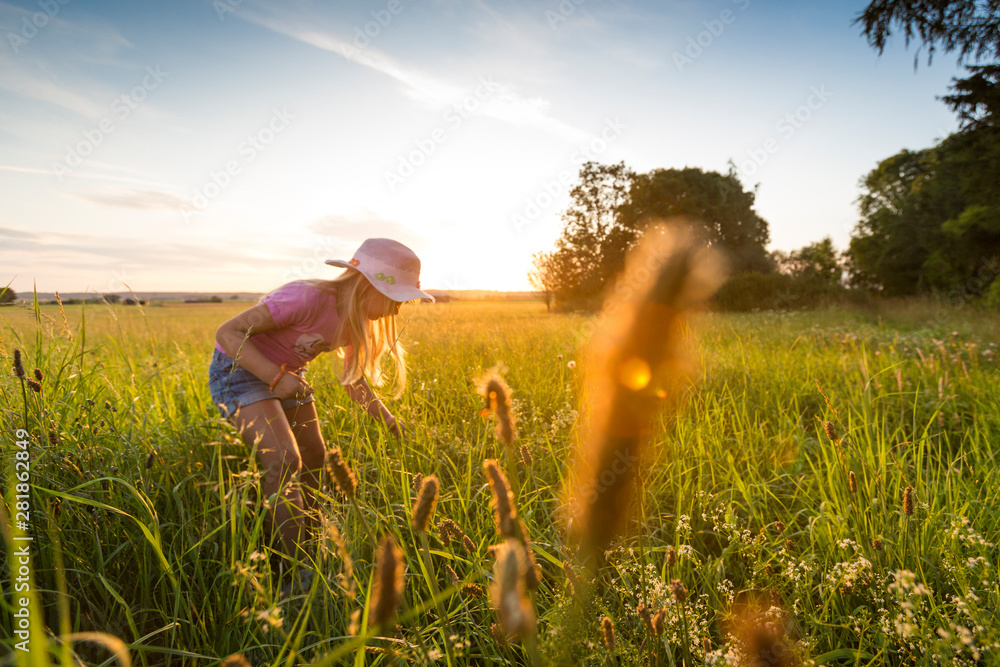 Fototapeta premium Happy girl enjoying the sunset at the countryside
