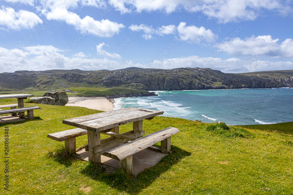 pick nick table with a view on an empty sandy beach on isle of Lewis in Scotland on a sunny day
