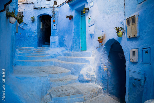 Turquoise narrow street with blue houses and stairway in Chefchaouen in Morocco © Marko Rupena