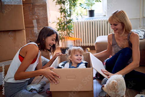 gay woman’s with a toddler girl moving in new home. photo