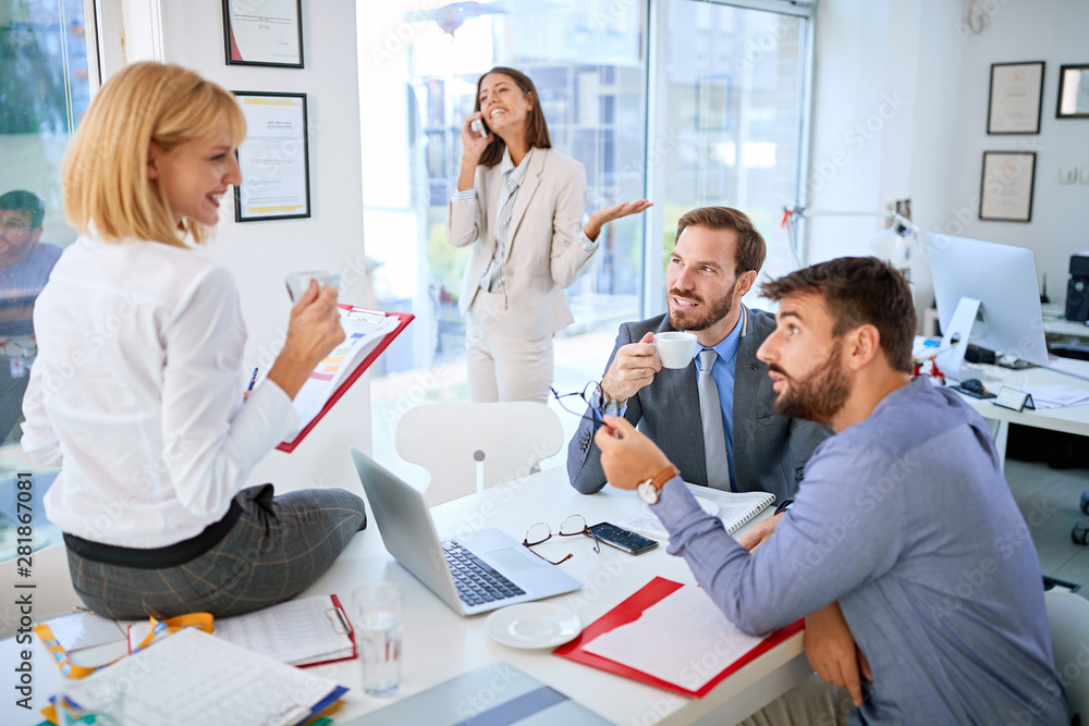 Group of business people working and communicating together in creative office. Group of business people working and communicating together in creative office.