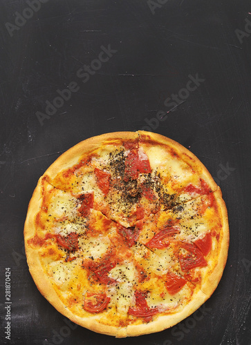 Delicious pizza on dark board.