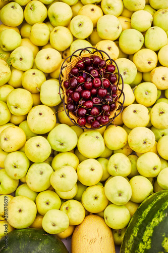 Yellow ripe apples  pile of fresh apple fruits  basket with cherries