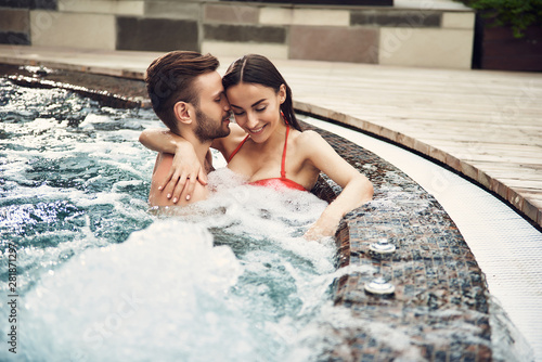 Loving couple having rest in the swimming pool