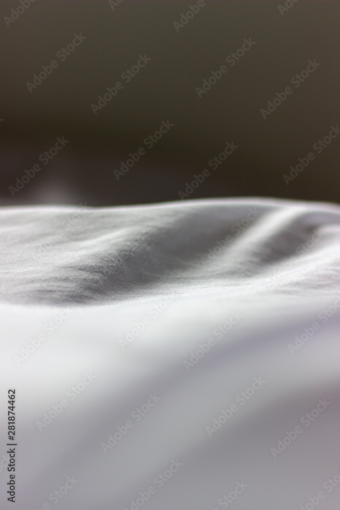 Folds in white cloth close up Folds in white cloth close up