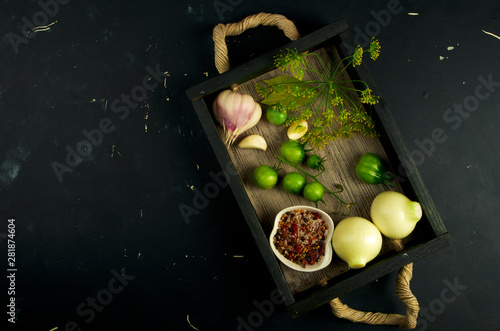 TEXTURE OF VEGETABLES IN A BOX ON A DARK BACKGROUND. CONCEPT OF PREPARING VEGETABLES FOR WINTER.