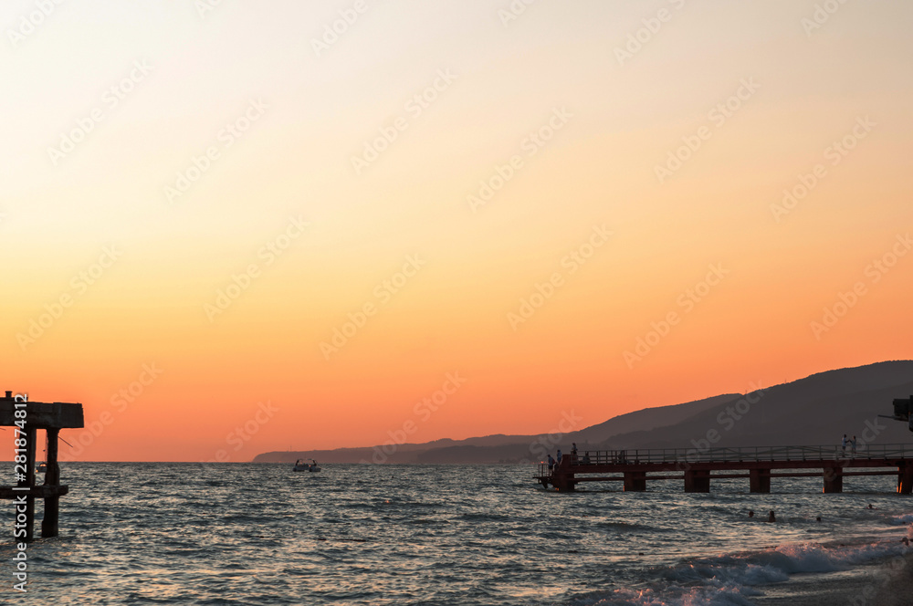 seascape and mountains at sunset on a summer day