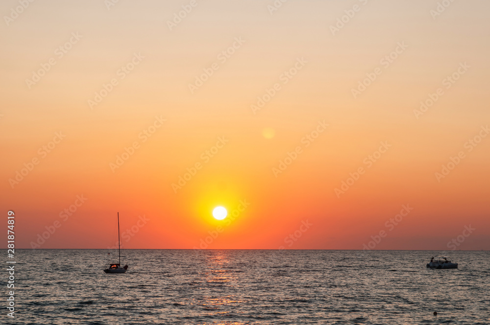 seascape and sunset, turquoise waves and orange sky