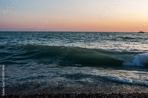 seascape and sunset, turquoise waves and orange sky